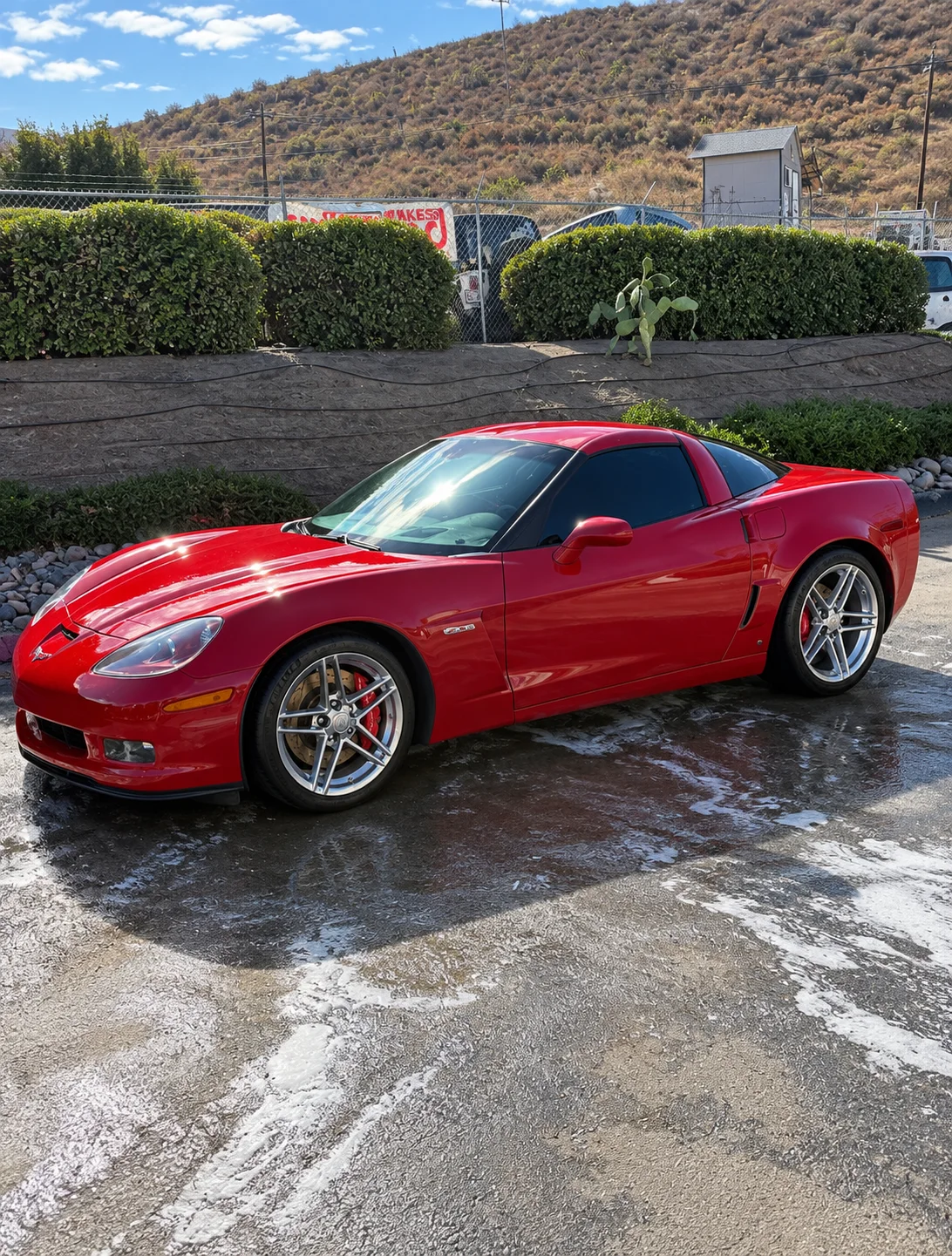 Red Corvette with dark window tint and a clean finished exterior