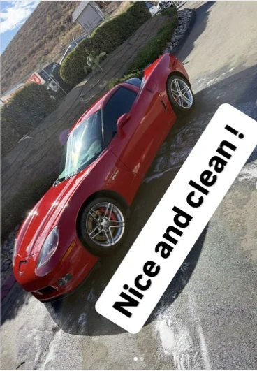Red sports car with a clean reflective finish after detailing