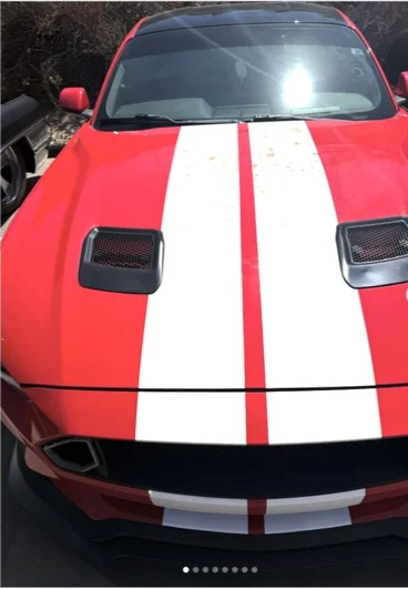 Red and white performance vehicle photographed after styling work