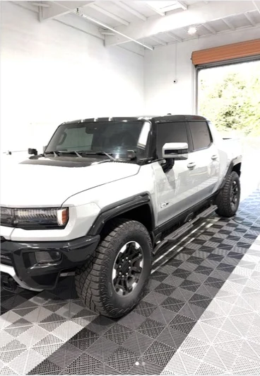 White truck inside the Bowtie Auto Styling shop